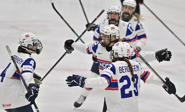 Andrea Dalen of Norway, center, celebrates her goal during the ice hockey IIHF Women's World Championship Group B match Japan vs Norway, in Ceske Budejovice, Czech Republic, Thursday, April 10, 2025. (Vaclav Pancer/CTK via AP)
