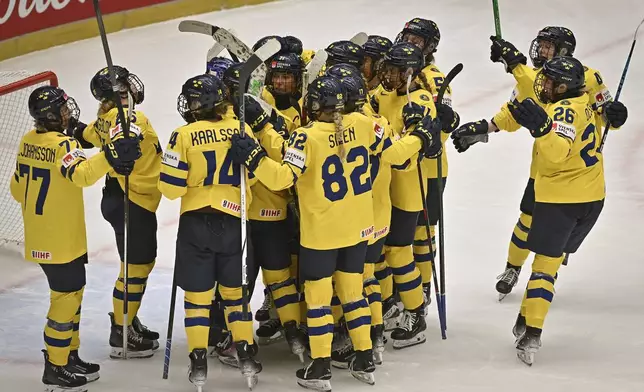 Sweden players celebrate a win over Hungary in a Group B match at the women's ice hockey world championships, Thursday, April 10, 2025, in Ceske Budejovice, Czech Republic. (Lubos Pavlicek/CTK via AP)