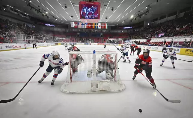 From left, Ida Haave of Norway, Kohane Sato of Japan, goalkeeper Miyuu Masuhara of Japan and Aoi Shiga of Japan in action during the ice hockey IIHF Women's World Championship Group B match Japan vs Norway, in Ceske Budejovice, Czech Republic, Thursday, April 10, 2025. (Vaclav Pancer/CTK via AP)