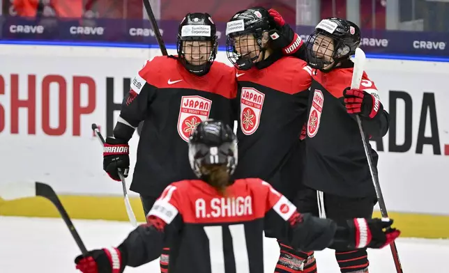 From left, Japan's Kohane Sato, Akane Shiga, Rui Ukita and Aoi Shiga celebrate a goal during the ice hockey IIHF Women's World Championship Group B match Japan vs Norway, in Ceske Budejovice, Czech Republic, Thursday, April 10, 2025. (Vaclav Pancer/CTK via AP)