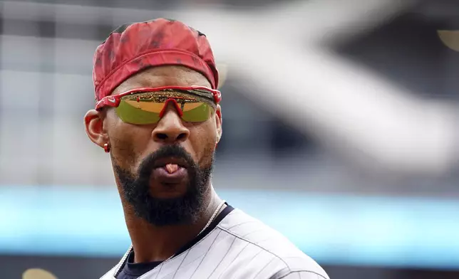 Minnesota Twins outfielder Byron Buxton (25) tries to blow a bubble between innings during a baseball game against the Minnesota Twins, Saturday, April 20, 2025, in Atlanta. (AP Photo/John David Mercer)