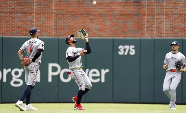 Minnesota Twins outfielder Byron Buxton (25) makes a catch for an out off of Atlanta Braves' Ozzie Albies, not pictured, during the third inning of a baseball game Saturday, April 20, 2025, in Atlanta. (AP Photo/John David Mercer)
