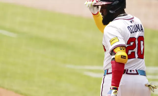 Atlanta Braves designated hitter Marcell Ozuna (20) tips his hat to the dugout while coming to the plate against the Minnesota Twins during the first inning of a baseball game Saturday, April 20, 2025, in Atlanta. (AP Photo/John David Mercer)