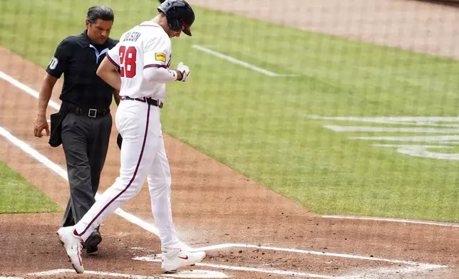 Atlanta Braves' Matt Olson (28) touches home plate after his two-run home run against the Minnesota Twins during the first inning of a baseball game Saturday, April 20, 2025, in Atlanta. (AP Photo/John David Mercer)