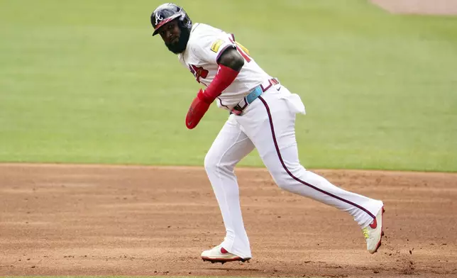 Atlanta Braves designated hitter Marcell Ozuna (20) runs the bases against the Minnesota Twins during the first inning of a baseball game Saturday, April 20, 2025, in Atlanta. (AP Photo/John David Mercer)