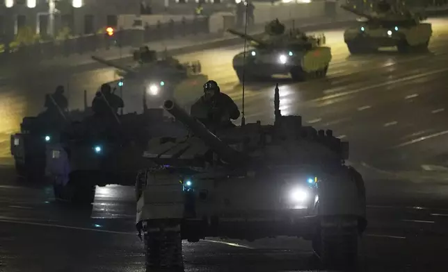 Russian T-90 tanks roll along Borovitskaya Square next to the Kremlin after a rehearsal for the Victory Day military parade in Moscow, Russia, on Tuesday, April 29, 2025. (AP Photo/Pavel Bednyakov)
