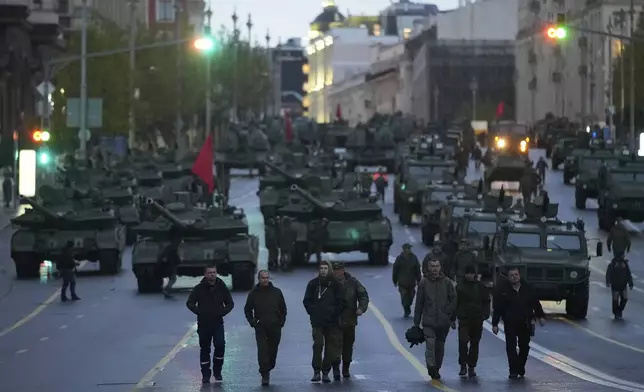 Russian servicemen walk along Tverskaya street toward Red Square to attend a rehearsal for the Victory Day military parade in Moscow, Russia, on Tuesday, April 29, 2025. (AP Photo/Pavel Bednyakov)