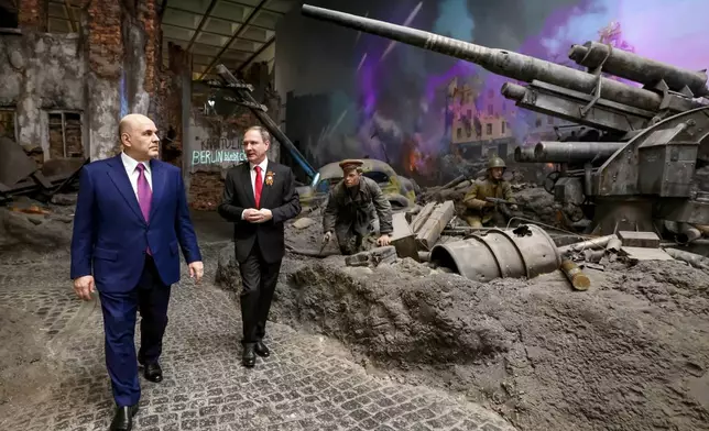 Russian Prime Minister Mikhail Mishustin, left, accompanied by Victory Museum Director Alexander Shkolnik, visits the Victory Museum on Poklonnaya Gora memorial complex ahead of celebrations of the 80th anniversary of the Soviet Union's victory over Nazi Germany during World War II in Moscow, Russia, Monday, April 28, 2025. (Dmitry Astakhov, Sputnik, Government Pool Photo via AP)