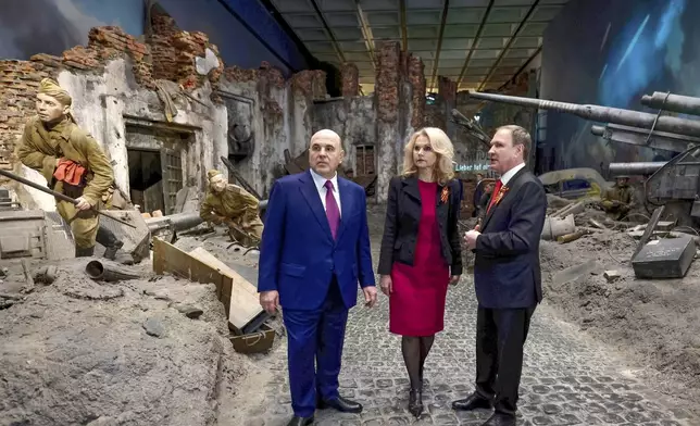Russian Prime Minister Mikhail Mishustin, left, accompanied by Deputy Prime Minister Tatyana Golikova, center, and Victory Museum Director Alexander Shkolnik, visits the Victory Museum on Poklonnaya Gora memorial complex ahead of celebrations of the 80th anniversary of the Soviet Union's victory over Nazi Germany during World War II in Moscow, Russia, Monday, April 28, 2025. (Dmitry Astakhov, Sputnik, Government Pool Photo via AP)