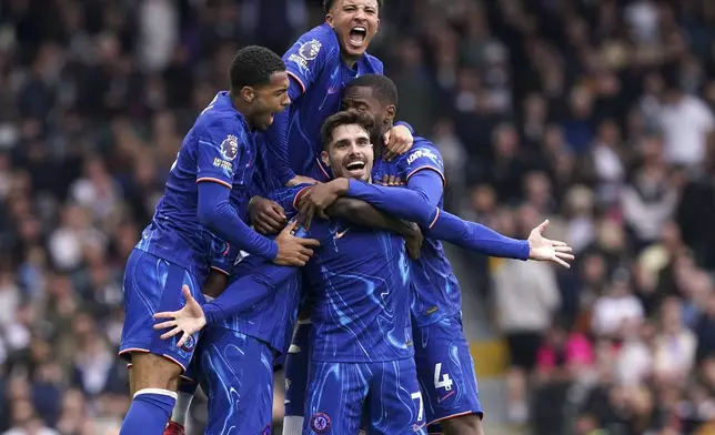 Chelsea's Pedro Neto, center, celebrates scoring his side's second goal of the game with teammates, during the English Premier League soccer match between Fulham and Chelsea, at Craven Cottage, London, Sunday April 20, 2025. (Jonathan Brady/PA via AP)