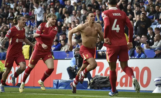 Liverpool's Trent Alexander-Arnold, second right, celebrates after scoring his side's opening goal during the English Premier League soccer match between Leicester City and Liverpool at King Power stadium in Leicester, England, Sunday, April 20, 2025. (AP Photo/Rui Vieira)