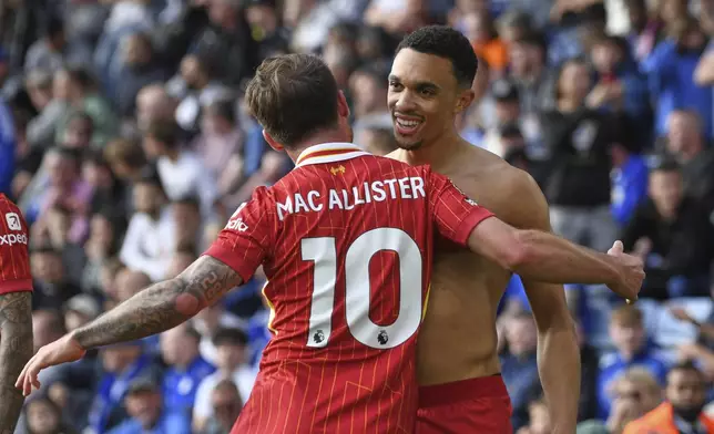 Liverpool's Trent Alexander-Arnold, right, celebrates with Liverpool's Alexis Mac Allister after scoring his side's opening goal during the English Premier League soccer match between Leicester City and Liverpool at King Power stadium in Leicester, England, Sunday, April 20, 2025. (AP Photo/Rui Vieira)