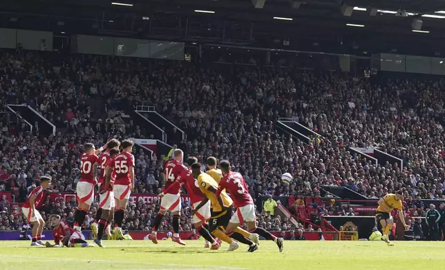Wolverhampton Wanderers' Pablo Sarabia, second from right, scores his side's first goal of the game, during the English Premier League soccer match between Manchester United and Wolverhampton Wanderers, at Old Trafford, Manchester, England, Sunday, April 20, 2025. (Martin Rickett/PA via AP)