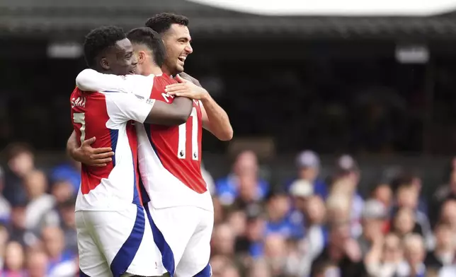 Arsenal's Gabriel Martinelli celebrates scoring his side's second goal of the game with teammates, during the English Premier League soccer match between Ipswich Town and Arsenal at Portman Road, Ipswich, England, Sunday, April 20, 2025. (John Walton/PA via AP)