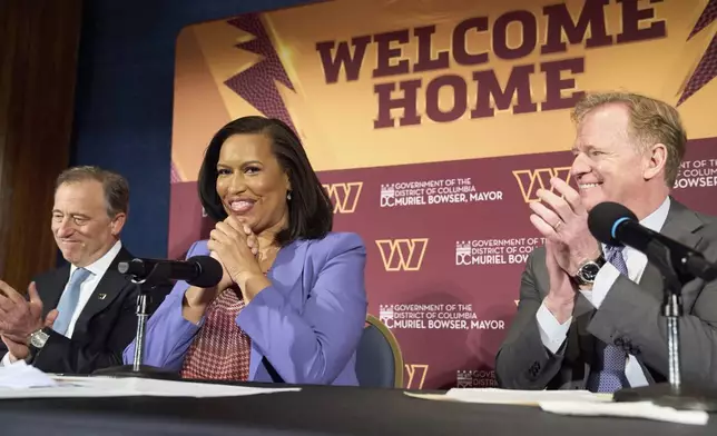 Washington Commanders controlling owner Josh Harris, from left, District of Columbia Mayor Muriel Bowser and NFL Commissioner Roger Goodell announce a new home for the NFL football team on the site of the old RFK Stadium, Monday, April 28, 2025, at the National Press Club in Washington. (AP Photo/Jacquelyn Martin)