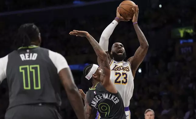 Los Angeles Lakers forward LeBron James, right, shoots as Minnesota Timberwolves guard Nickeil Alexander-Walker, center, and center Naz Reid defend during the first half in Game 1 of an NBA first-round playoff series Saturday, April 19, 2025, in Los Angeles. (AP Photo/Mark J. Terrill)