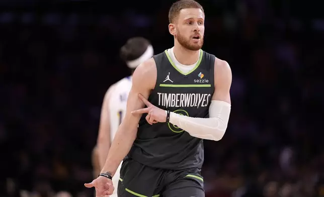 Minnesota Timberwolves guard Donte DiVincenzo gestures after making a three-point shot during the first half in Game 1 of an NBA first-round playoff series against the Los Angeles Lakers, Saturday, April 19, 2025, in Los Angeles. (AP Photo/Mark J. Terrill)