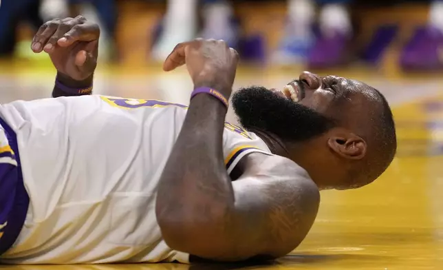 Los Angeles Lakers forward LeBron James reacts after being hit in the face by Minnesota Timberwolves forward Julius Randle as Randle was shooting during the second half in Game 1 of an NBA first-round playoff series Saturday, April 19, 2025, in Los Angeles. (AP Photo/Mark J. Terrill)