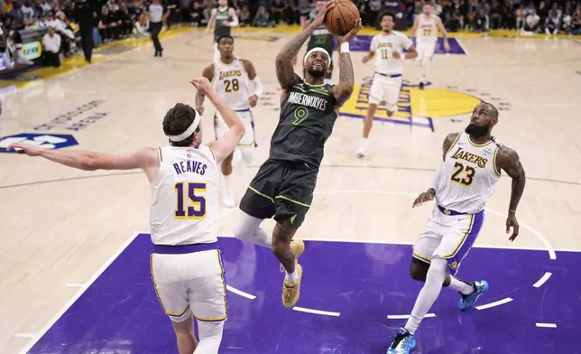 Minnesota Timberwolves guard Nickeil Alexander-Walker (9) shoots as Los Angeles Lakers guard Austin Reaves (15) and forward LeBron James (23) defend during the first half in Game 1 of an NBA first-round playoff series Saturday, April 19, 2025, in Los Angeles. (AP Photo/Mark J. Terrill)