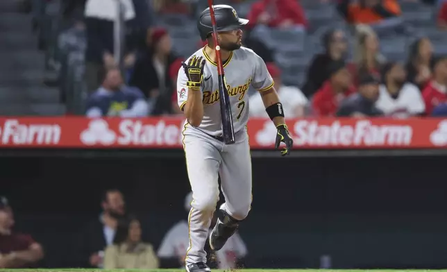 Pittsburgh Pirates' Isiah Kiner-Falefa (7) flips his bat after hitting an RBI double during the ninth inning of a baseball game against the Los Angeles Angels in Anaheim, Calif., Tuesday, April 22, 2025. (AP Photo/Jessie Alcheh)