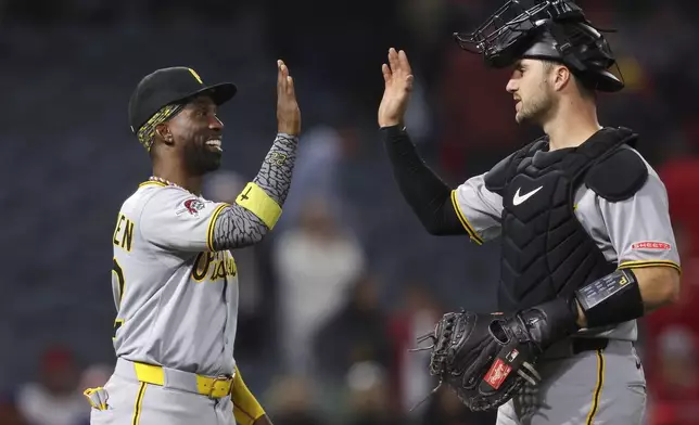 Pittsburgh Pirates' Andrew McCutchen, left, celebrates with catcher Joey Bart after the Pirates defeated the Los Angeles Angels in a baseball game in Anaheim, Calif., Tuesday, April 22, 2025. (AP Photo/Jessie Alcheh)