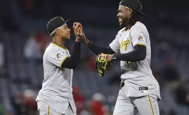 Pittsburgh Pirates outfielder Oneil Cruz celebrates with third baseman Ke'Bryan Hayes after defeating the Los Angeles Angels in a baseball game in Anaheim, Calif., Tuesday, April 22, 2025. (AP Photo/Jessie Alcheh)