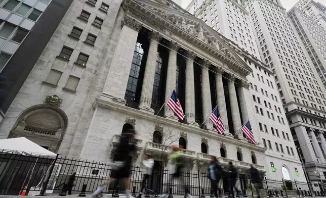People walk by the New York Stock Exchange, Thursday morning, April 10, 2025. (AP Photo/Richard Drew)