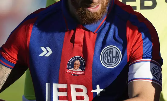 San Lorenzo's Iker Muniain wears a club jersey commemorating the late Pope Francis who was a lifelong supporter of the club, during a local soccer match against Rosario Central in Buenos Aires, Argentina, Saturday, April 26, 2025. (AP Photo/Gustavo Garello)