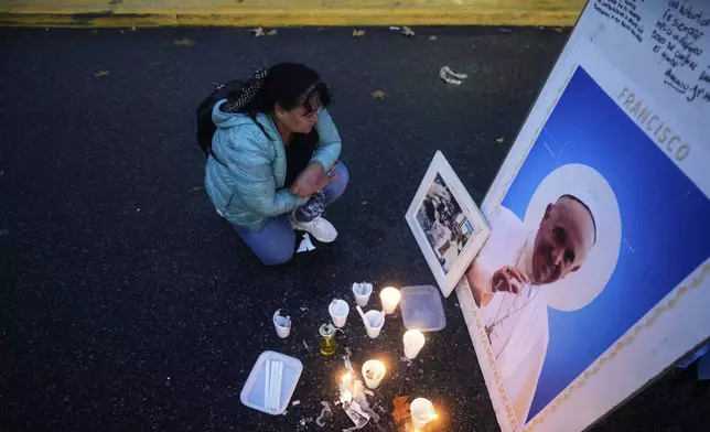 Griselda Moreira pays tribute to the late Pope Francis outside the Cathedral in Buenos Aires, Argentina, Saturday, April 26, 2025, as his funeral takes place in Rome. (AP Photo/Natacha Pisarenko)