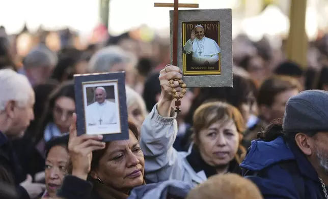 Mourners pay tribute to the late Pope Francis during a Mass outside the Cathedral in Buenos Aires, Argentina, Saturday, April 26, 2025. (AP Photo/Natacha Pisarenko)