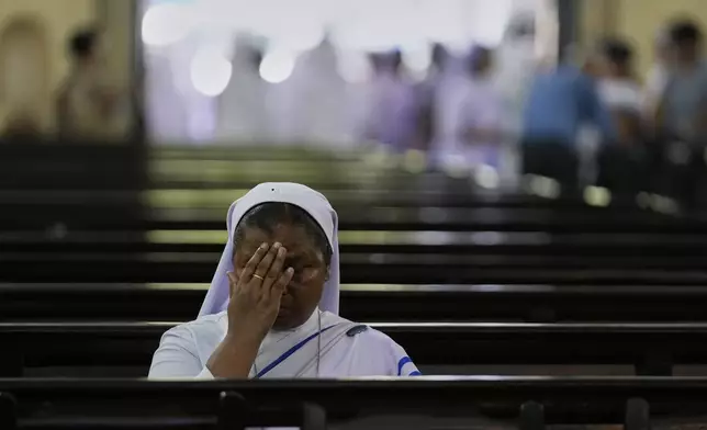 A Catholic nun prays as she attends a service for the late Pope Francis at the Cathedral of The Most Holy Rosary, in Kolkata, India, Saturday, April 26, 2025. (AP Photo/Bikas Das)
