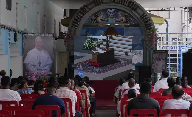 Catholics watch a live telecast of Pope Francis funeral ceremony in St. Peter's Square at the Vatican, at the Shrine of Our Lady of Good Health Church in Hyderabad, India, Saturday, April 26, 2025. (AP Photo/Mahesh Kumar A.)