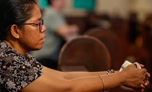 A Catholic devotee prays during the papal funeral public viewing at the Sacred Heart Parish Church in Quezon City, Philippines, Saturday, April 26, 2025. (AP Photo/Gerard Carreon)