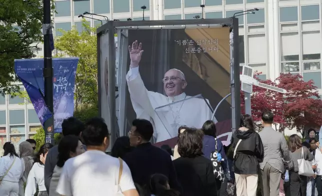 A portrait of the late Pope Francis is displayed outside Myeongdong Cathedral in Seoul, South Korea, Saturday, April 26, 2025.(AP Photo/Ahn Young-joon)