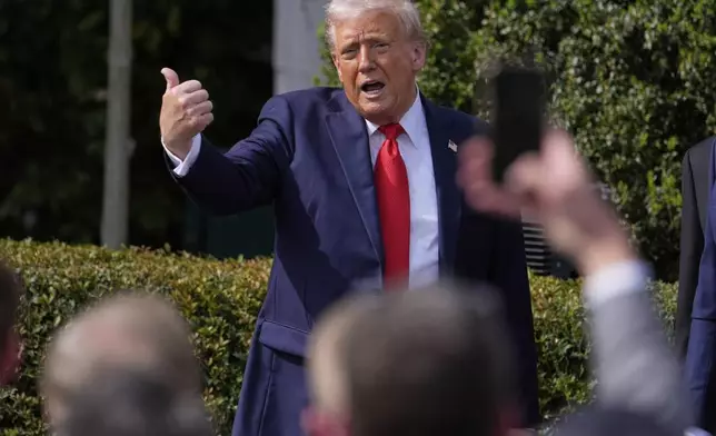 President Donald Trump gestures to the crowd as he departs after welcoming the 2025 College Football National Champions, the Ohio State University football team, during an event on the South Lawn of the White House, Monday, April 14, 2025, in Washington. (AP Photo/Manuel Balce Ceneta)