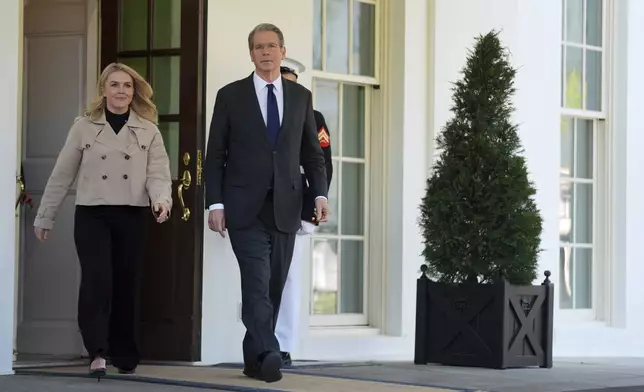 Treasury Secretary Scott Bessent and White House press secretary Karoline Leavitt walk to speak with reporters outside the West Wing of the White House, Wednesday, April 9, 2025, in Washington. (AP Photo/Evan Vucci)