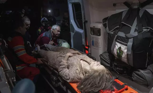 Medics tend to an injured woman in an ambulance near a house destroyed by a Russian airstrike in a residential neighbourhood in Kyiv, Ukraine, on Thursday, April 24, 2025. (AP Photo/Evgeniy Maloletka)