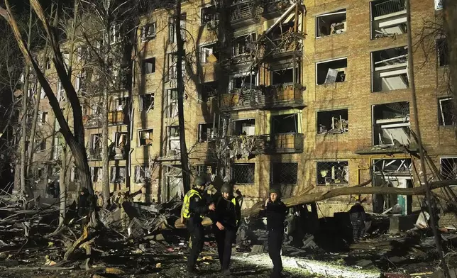 Ukrainian police officers stand near a damaged building after a Russian ballistic missile attack in Kyiv, Ukraine, early Thursday, April 24, 2025. (AP Photo/Efrem Lukatsky)