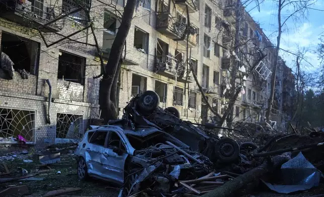 Damaged cars lie in a yard with other debris after a Russian ballistic missile attack in Kyiv, Ukraine, Thursday, April 24, 2025. (AP Photo/Efrem Lukatsky)