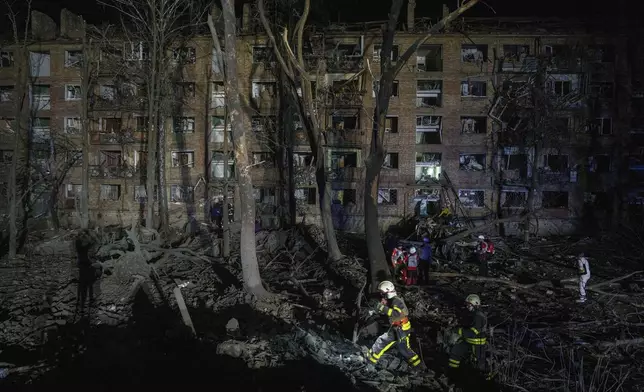 Rescue workers clear the rubble at a house damaged by a Russian airstrike in a residential neighborhood in Kyiv, Ukraine, on Thursday, April 24, 2025. (AP Photo/Evgeniy Maloletka)