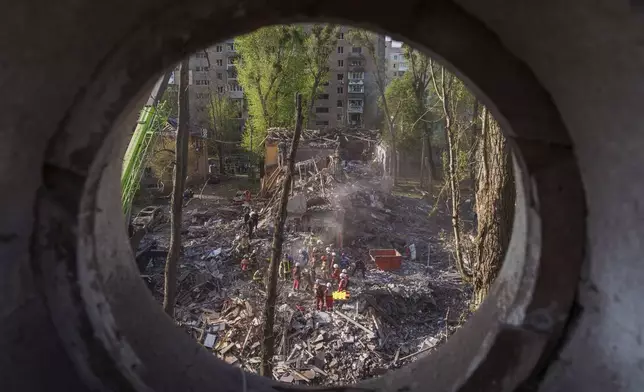 Rescue workers clear the rubble of a house destroyed by a Russian strike on a residential neighbourhood in Kyiv, Ukraine, on Thursday, April 24, 2025. (AP Photo/Evgeniy Maloletka)