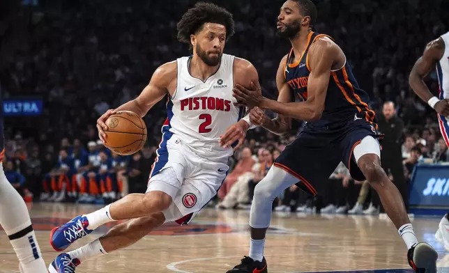 Detroit Pistons guard Cade Cunningham (2) drives toward the basket against New York Knicks' Mikal Bridges during the first half of Game 2 of an NBA basketball first-round playoff series, Monday, April 21, 2025, in New York. (AP Photo/Angelina Katsanis)