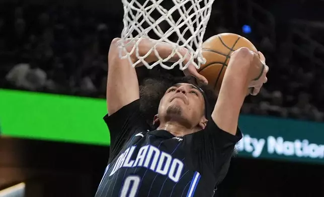 Orlando Magic guard Anthony Black (0) dunks the ball against the Atlanta Hawks during the second half of an NBA basketball game, Tuesday, April 8, 2025, in Orlando, Fla. (AP Photo/John Raoux)