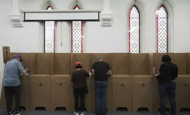 People cast there ballots at a polling place as early voting begins in Sydney, Tuesday, April 22, 2025, for a national election to be held on May 3. (AP Photo/Mark Baker)