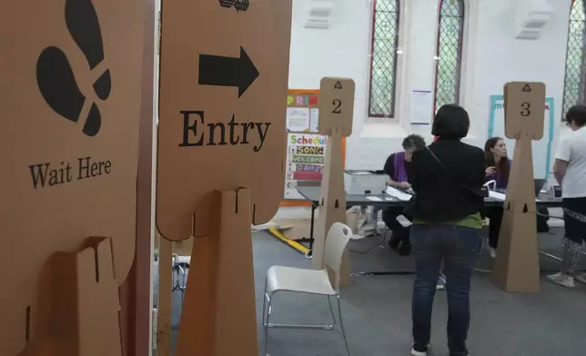 People arrive at a polling place as early voting begins in Sydney, Tuesday, April 22, 2025, for a national election to be held on May 3. (AP Photo/Mark Baker)