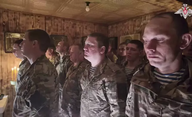 In this image from video distributed by the Russian Defense Ministry Press Service on Sunday, April 20, 2025, Russian soldiers attend a religious service on eve of Orthodox Easter at an unspecified location in Ukraine. (Russian Defense Ministry Press Service via AP)