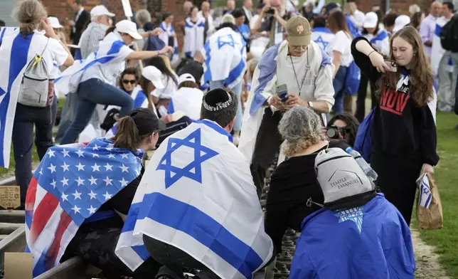 People attend the "March of the Living", the annual Holocaust remembrance event in memory of the six million Holocaust victims, at the former Nazi German death camp of Auschwitz-Birkenau in Oswiecim, Poland, Thursday, April 24, 2025. (AP Photo/Czarek Sokolowski)