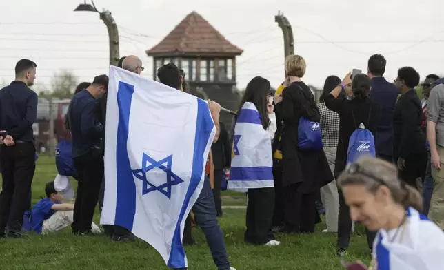 People attend the "March of the Living", the annual Holocaust remembrance event in memory of the six million Holocaust victims, at the former Nazi German death camp of Auschwitz-Birkenau in Oswiecim, Poland, Thursday, April 24, 2025. (AP Photo/Czarek Sokolowski)