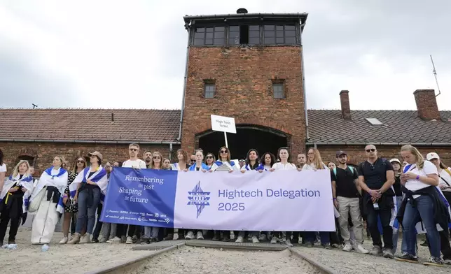 People attend the "March of the Living", the annual Holocaust remembrance event in memory of the six million Holocaust victims, at the former Nazi German death camp of Auschwitz-Birkenau in Oswiecim, Poland, Thursday, April 24, 2025. (AP Photo/Czarek Sokolowski)