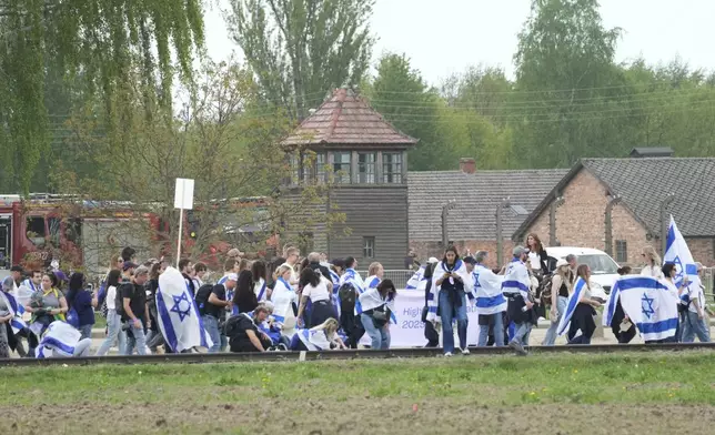 People attend the "March of the Living", the annual Holocaust remembrance event in memory of the six million Holocaust victims, at the former Nazi German death camp of Auschwitz-Birkenau in Oswiecim, Poland, Thursday, April 24, 2025. (AP Photo/Czarek Sokolowski)